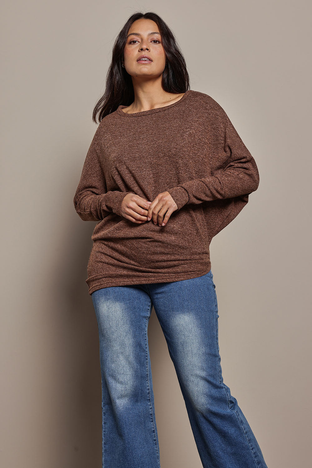 Model Tahnee wearing size 10 of the Snuggle Up Jumper in colour Chocolate, from the front, cropped image