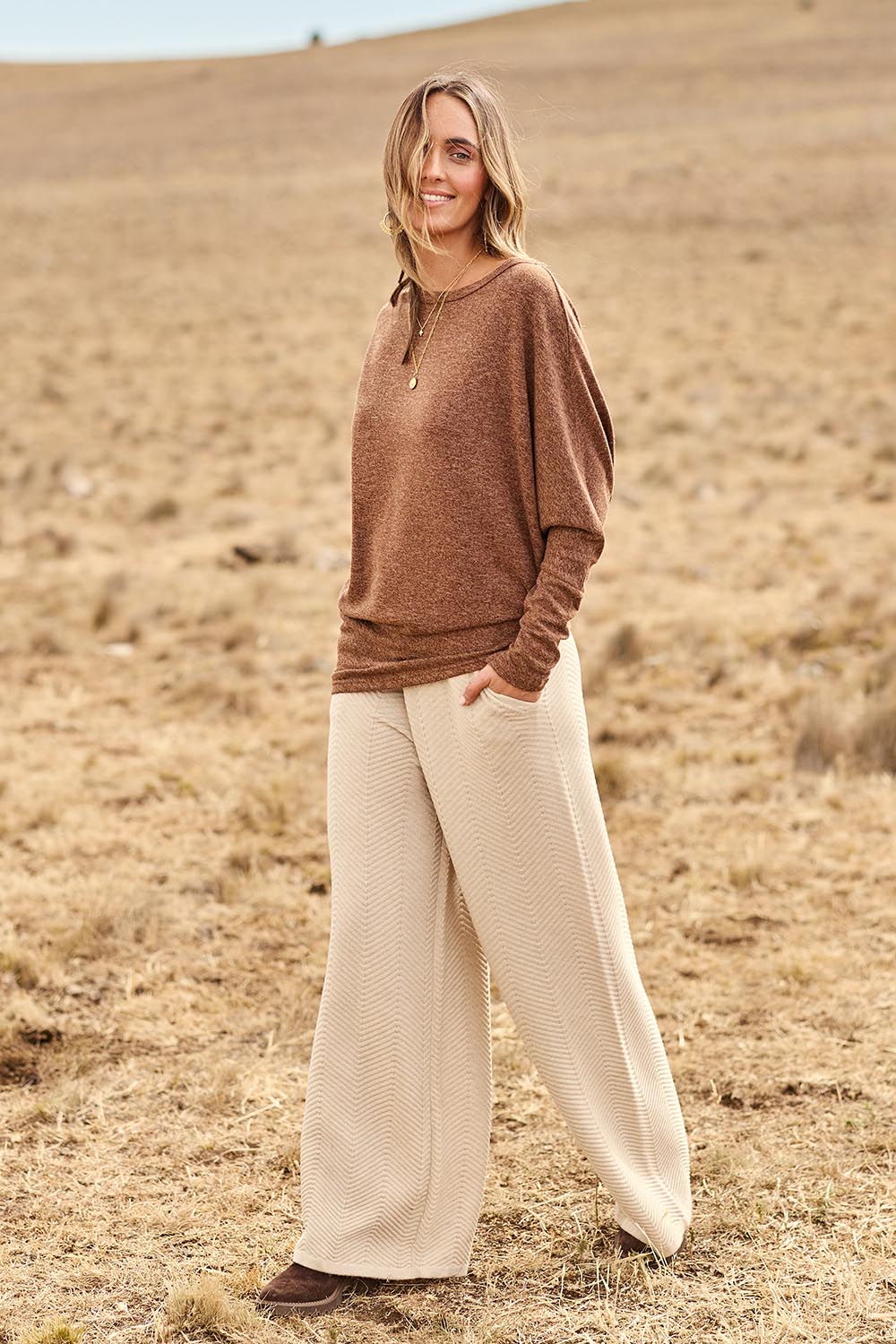 Model Tegan wearing size 10 of the Snuggle Up Jumper in colour Chocolate, from the front, showing the whole outfit
