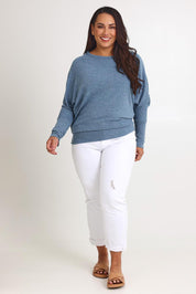Model Ashleigh wearing size 16 of the Snuggle Up Jumper in colour Denim (Blue), from the front, showing the whole outfit
