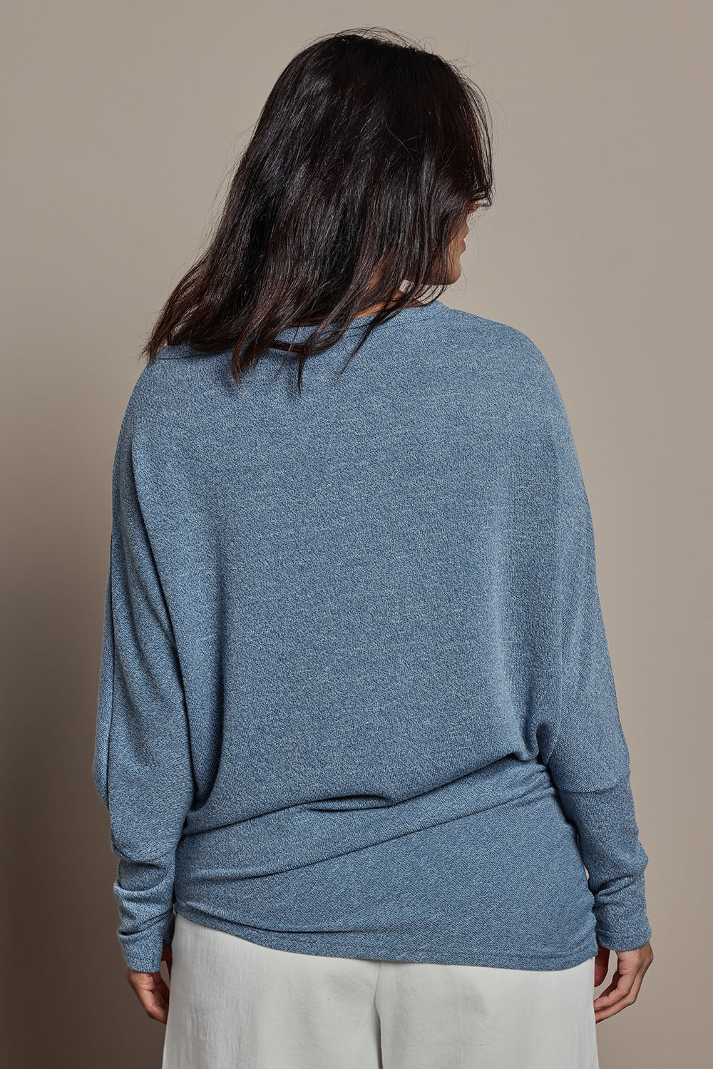 Model Tahnee wearing size 10 of the Snuggle Up Jumper in colour Denim (Blue), from the back
