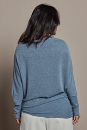 Model Tahnee wearing size 10 of the Snuggle Up Jumper in colour Denim (Blue), from the back