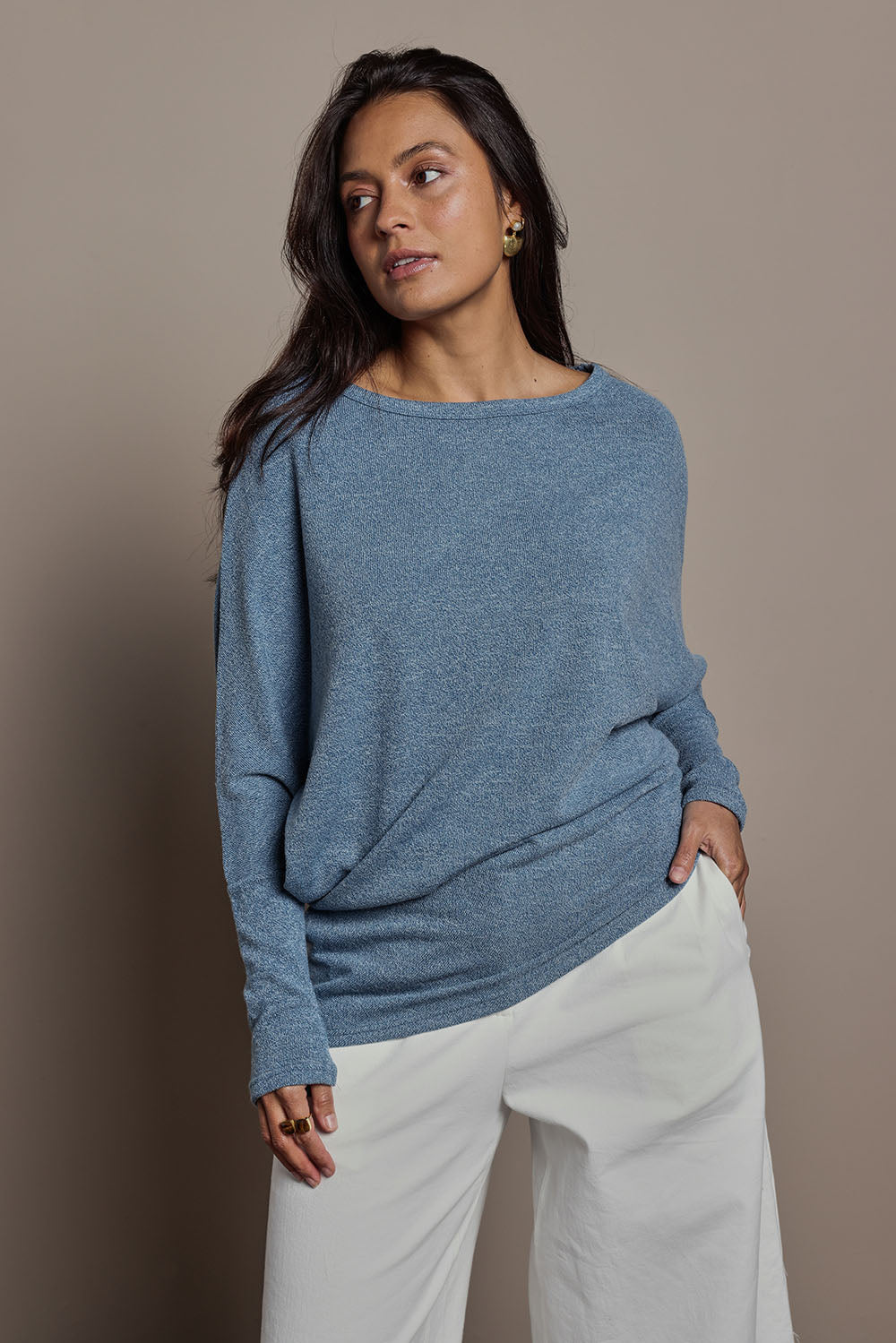 Model Tahnee wearing size 10 of the Snuggle Up Jumper in colour Denim (Blue), from the front, cropped image