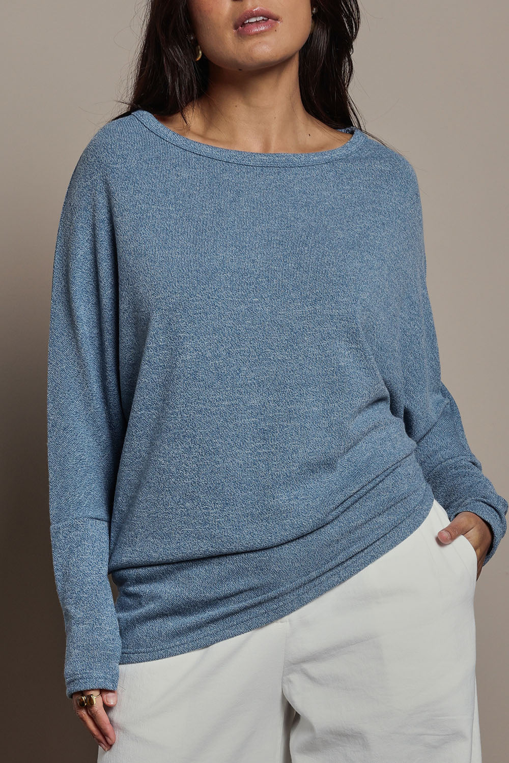 Model Tahnee wearing size 10 of the Snuggle Up Jumper in colour Denim (Blue), from the front, cropped image