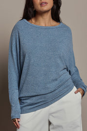 Model Tahnee wearing size 10 of the Snuggle Up Jumper in colour Denim (Blue), from the front, cropped image