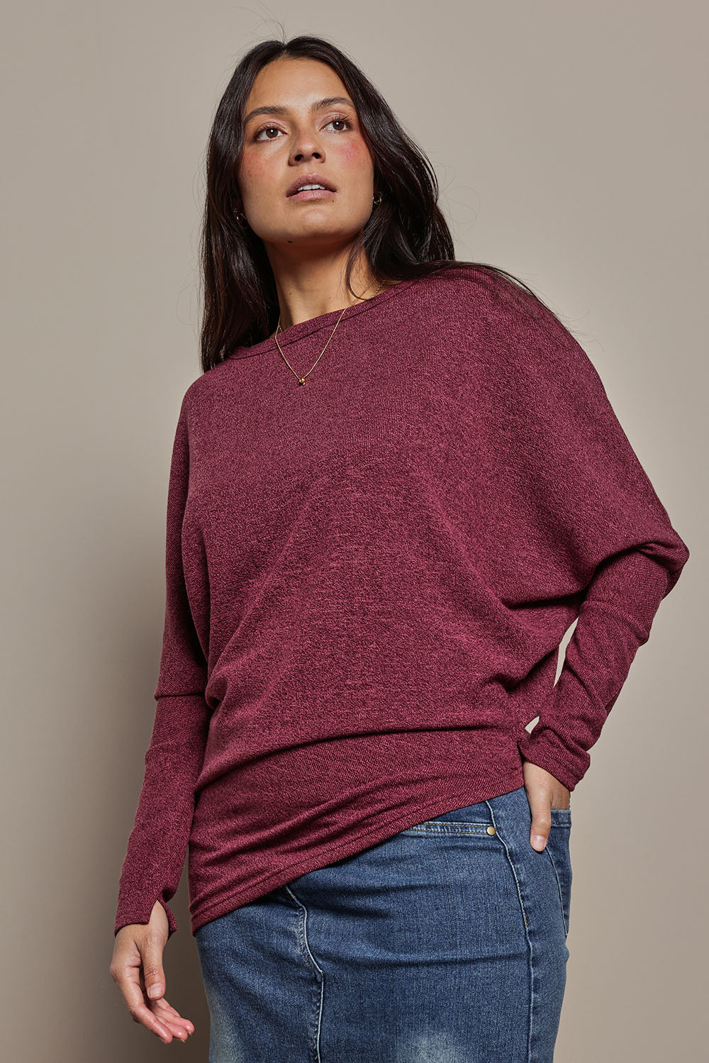 Model Tahnee wearing size 10 of the Snuggle Up Jumper in colour Grape (Purple), from the front, cropped image
