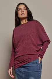 Model Tahnee wearing size 10 of the Snuggle Up Jumper in colour Grape (Purple), from the front, cropped image