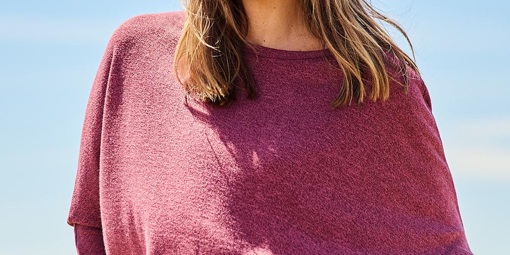 Model Tegan wearing size 10 of the Snuggle Up Jumper in colour Grape (Purple), from the front, showing the whole outfit