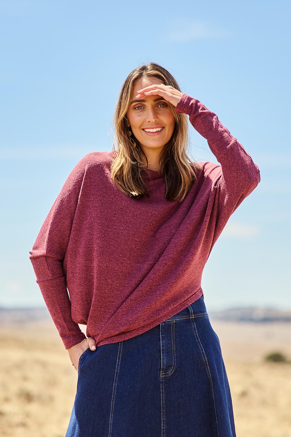Model Tegan wearing size 10 of the Snuggle Up Jumper in colour Grape (Purple), from the front, showing the whole outfit