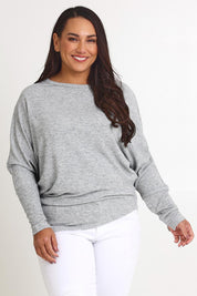 Model Ashleigh wearing size 16 of the Snuggle Up Jumper in colour Greymarl (Grey), from the front, cropped image