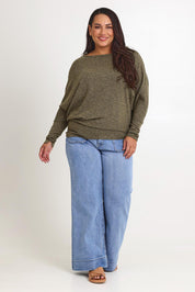 Model Ashleigh wearing size 16 of the Snuggle Up Jumper in colour Gum (Green), from the front, showing the whole outfit
