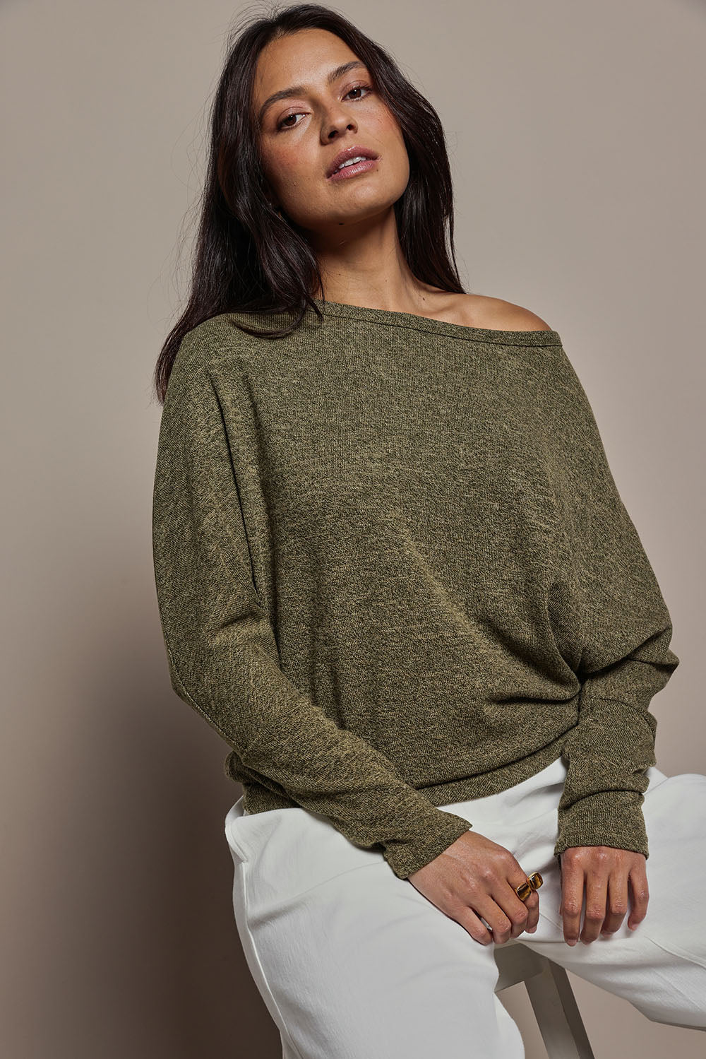 Model Tahnee wearing size 10 of the Snuggle Up Jumper in colour Gum (Green), from the front, cropped image