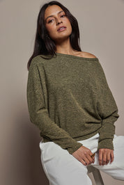 Model Tahnee wearing size 10 of the Snuggle Up Jumper in colour Gum (Green), from the front, cropped image