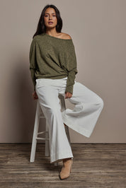 Model Tahnee wearing size 10 of the Snuggle Up Jumper in colour Gum (Green), from the front, showing the whole outfit