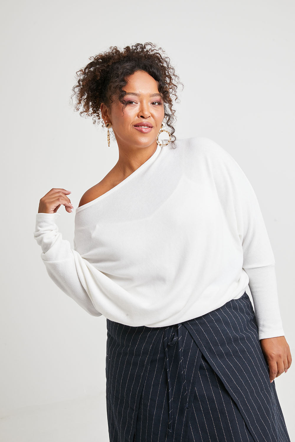 Model Alexis wearing size 16 of the Snuggle Up Jumper in colour Ivory (White), from the front, cropped image