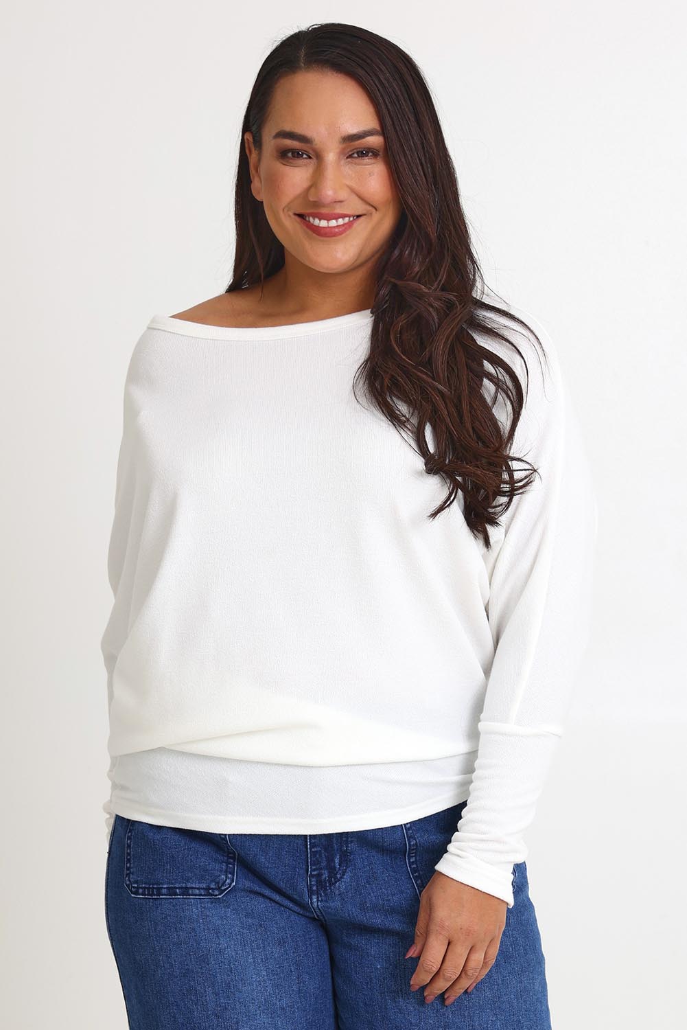 Model Ashleigh wearing size 16 of the Snuggle Up Jumper in colour Ivory (White), from the front, cropped image