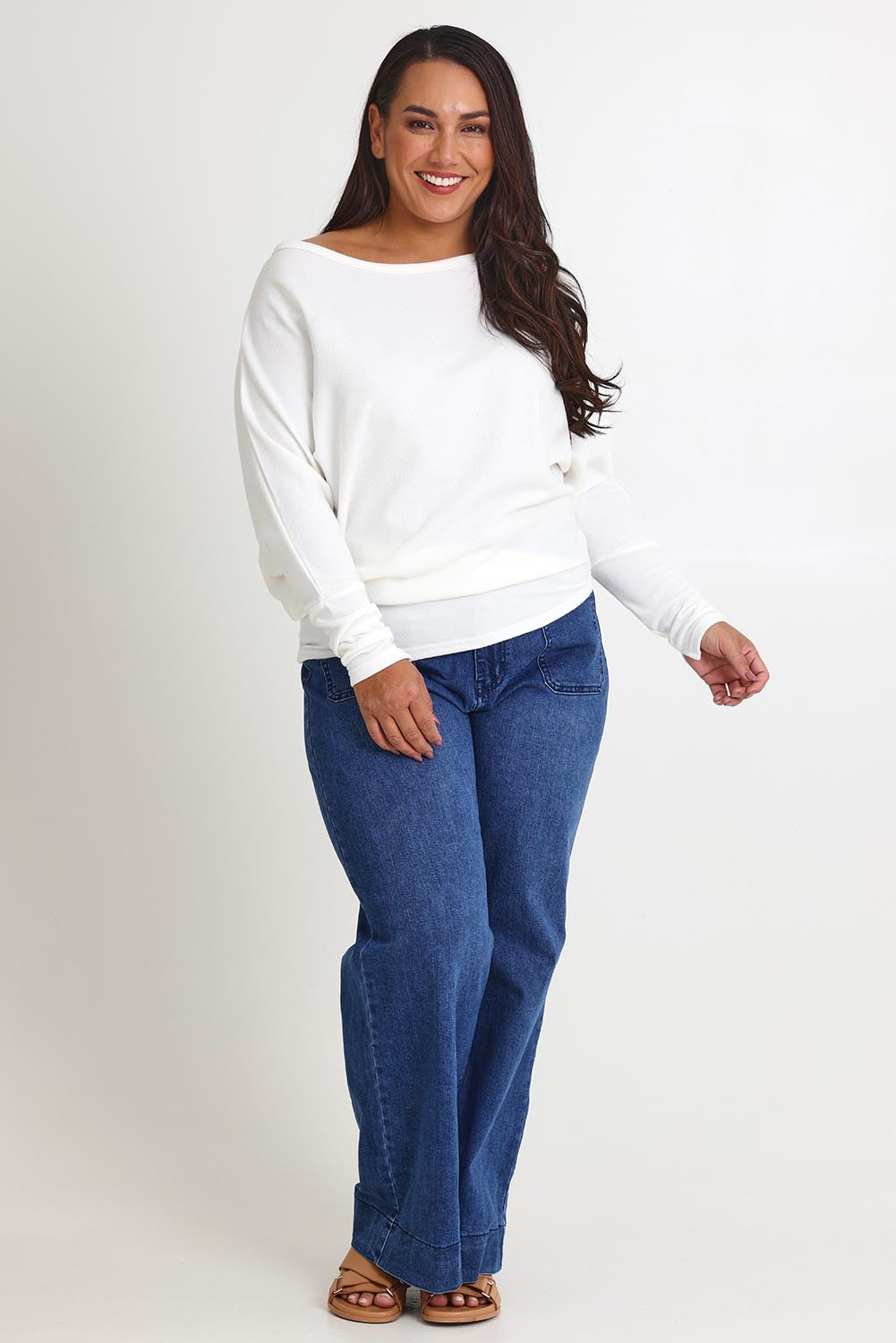Model Ashleigh wearing size 16 of the Snuggle Up Jumper in colour Ivory (White), from the front, showing the whole outfit