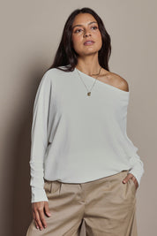 Model Tahnee wearing size 10 of the Snuggle Up Jumper in colour Ivory (White), from the front, cropped image