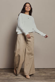 Model Tahnee wearing size 10 of the Snuggle Up Jumper in colour Ivory (White), from the front, showing the whole outfit