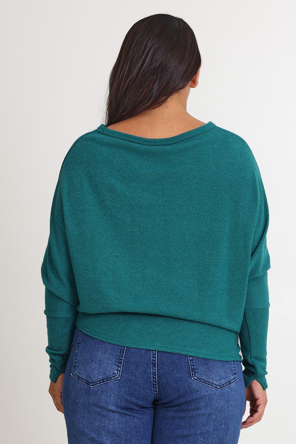 Model Ashleigh wearing size 16 of the Snuggle Up Jumper in colour Jade (Green), from the back