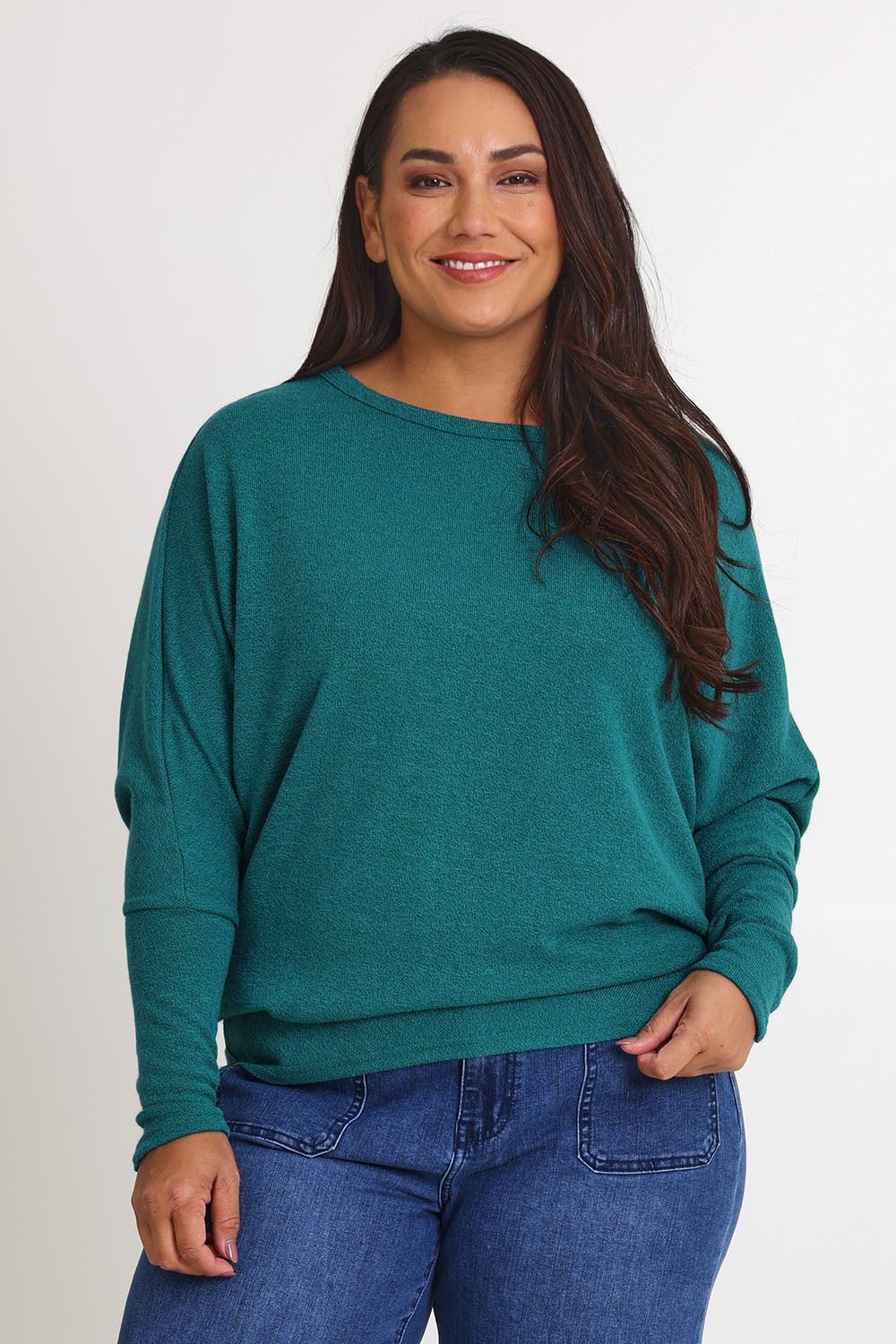 Model Ashleigh wearing size 16 of the Snuggle Up Jumper in colour Jade (Green), from the front, cropped image