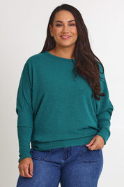 Model Ashleigh wearing size 16 of the Snuggle Up Jumper in colour Jade (Green), from the front, cropped image