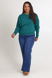 Model Ashleigh wearing size 16 of the Snuggle Up Jumper in colour Jade (Green), from the front, showing the whole outfit