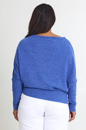 Model Ashleigh wearing size 16 of the Snuggle Up Jumper in colour Lapis (Blue), from the back