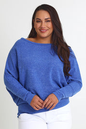 Model Ashleigh wearing size 16 of the Snuggle Up Jumper in colour Lapis (Blue), from the front, cropped image