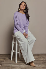 Model Tahnee wearing size 10 of the Snuggle Up Jumper in colour Lavender (Purple), from the front, showing the whole outfit