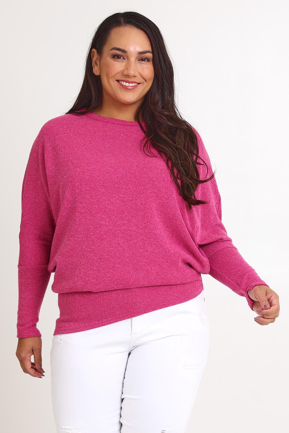 Model Ashleigh wearing size 16 of the Snuggle Up Jumper in colour Magenta (Pink), from the front, cropped image