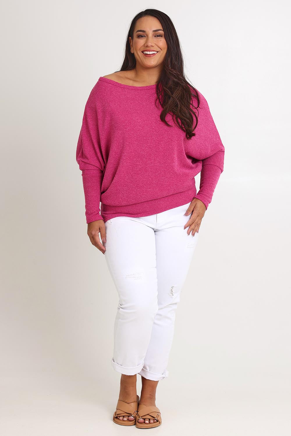 Model Ashleigh wearing size 16 of the Snuggle Up Jumper in colour Magenta (Pink), from the front, showing the whole outfit