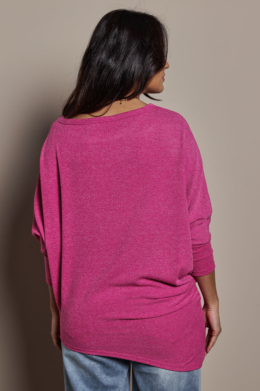 Model Tahnee wearing size 10 of the Snuggle Up Jumper in colour Magenta (Pink), from the back