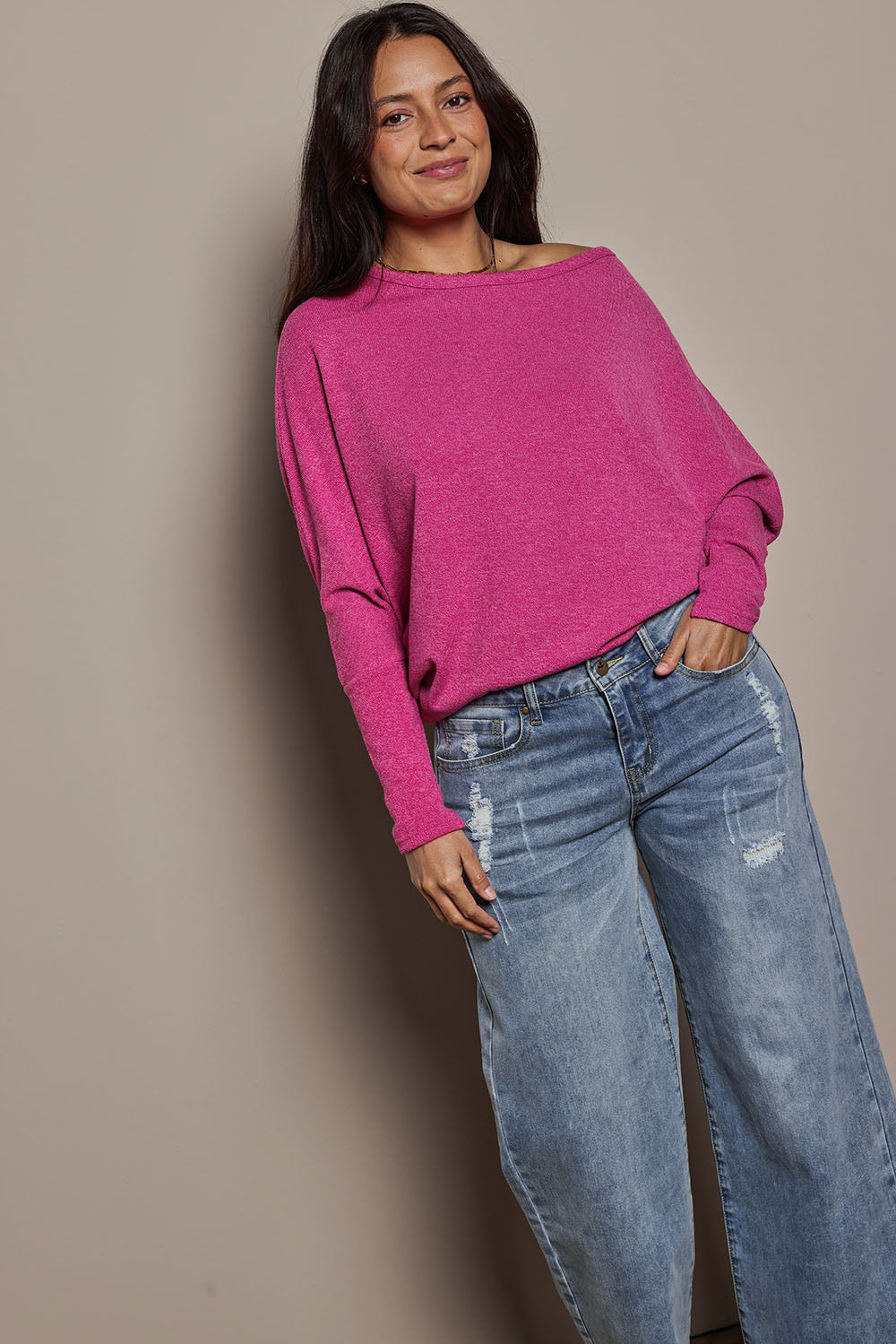 Model Tahnee wearing size 10 of the Snuggle Up Jumper in colour Magenta (Pink), from the front, showing the whole outfit