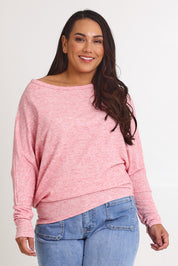 Model Ashleigh wearing size 16 of the Snuggle Up Jumper in colour Pinkmarl (Pink), from the front, cropped image