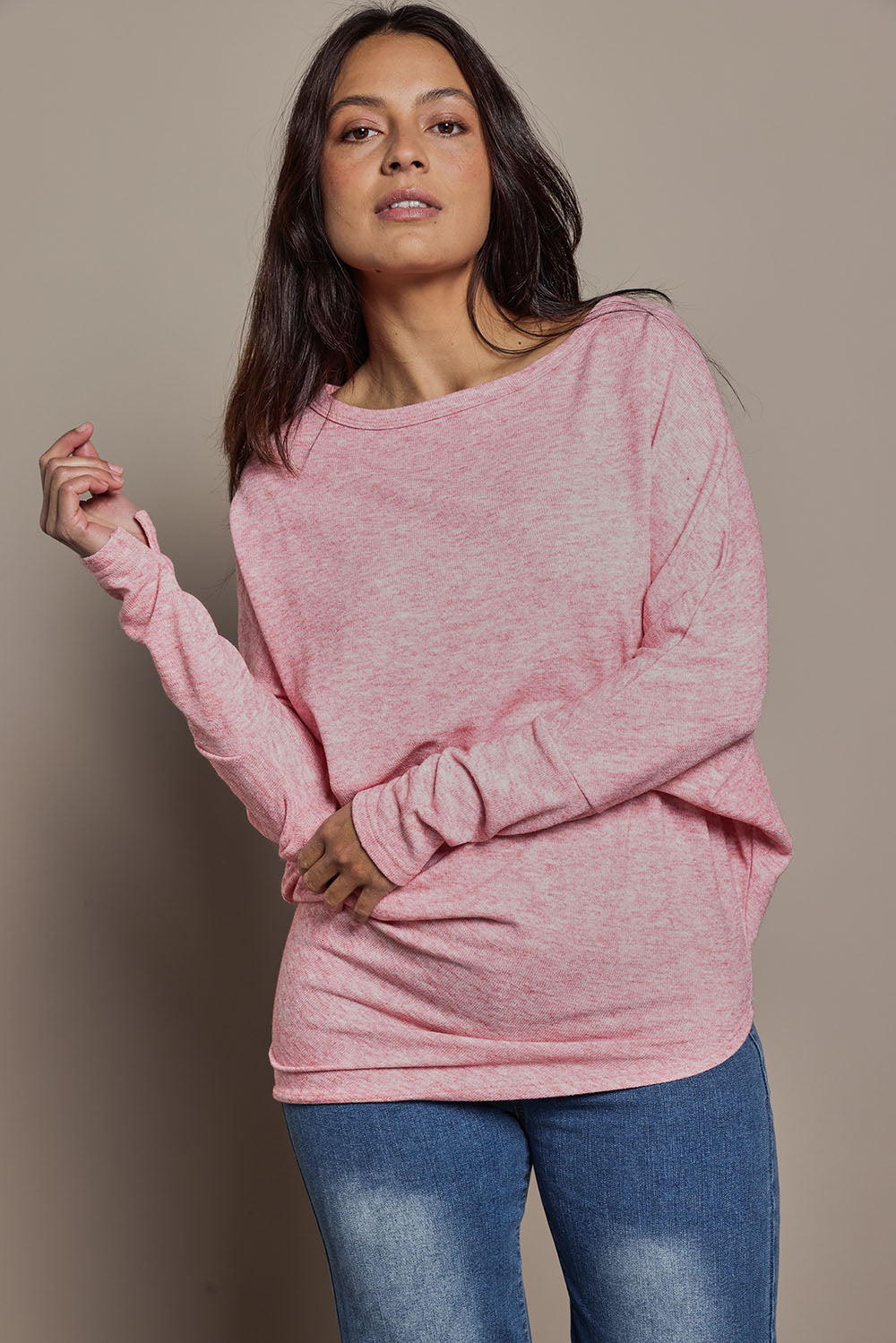 Model Tahnee wearing size 10 of the Snuggle Up Jumper in colour Pinkmarl (Pink), from the front, cropped image