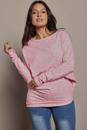 Model Tahnee wearing size 10 of the Snuggle Up Jumper in colour Pinkmarl (Pink), from the front, cropped image