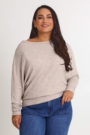 Model Ashleigh wearing size 16 of the Snuggle Up Jumper in colour Sandmarl, from the front, cropped image