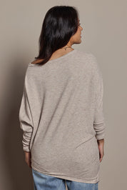 Model Tahnee wearing size 10 of the Snuggle Up Jumper in colour Sandmarl, from the back