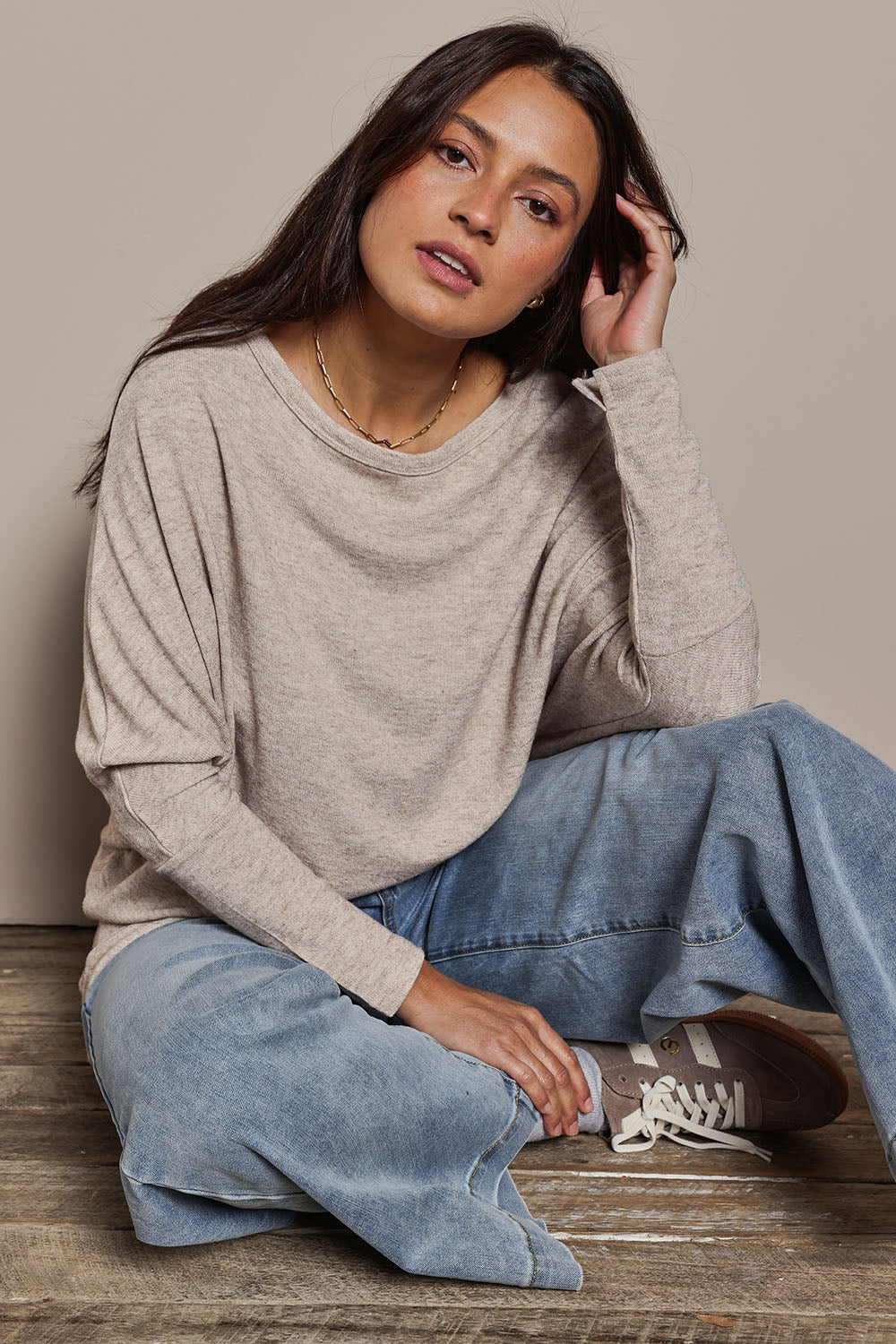 Model Tahnee wearing size 10 of the Snuggle Up Jumper in colour Sandmarl, from the front, showing the whole outfit
