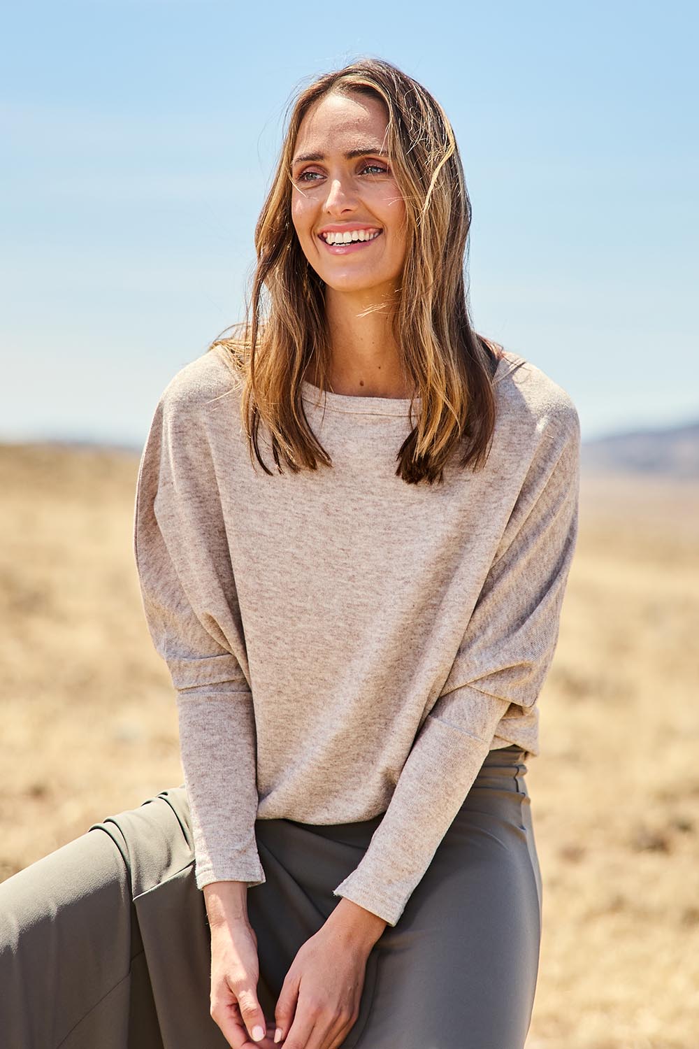 Model Tegan wearing size 10 of the Snuggle Up Jumper in colour Sandmarl, from the front, showing the whole outfit