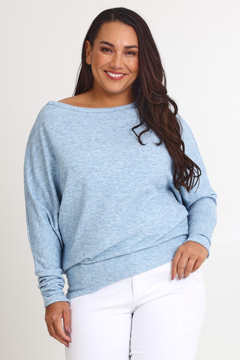 Model Ashleigh wearing size 16 of the Snuggle Up Jumper in colour Skymarl (Blue), from the front, cropped image