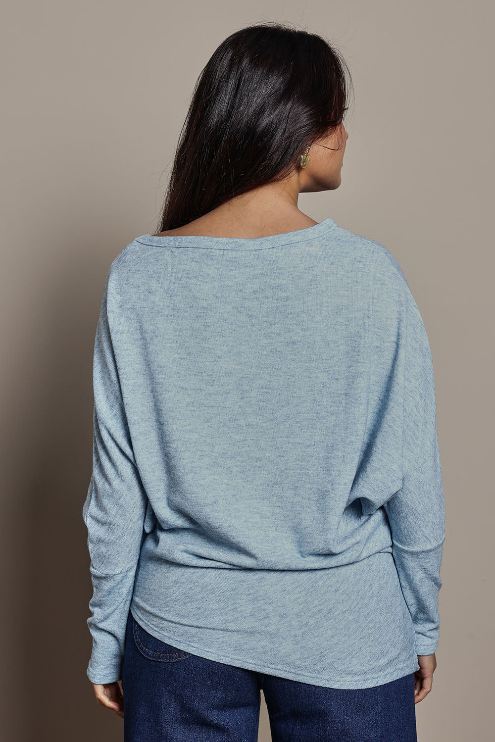 Model Tahnee wearing size 10 of the Snuggle Up Jumper in colour Skymarl (Blue), from the back