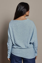 Model Tahnee wearing size 10 of the Snuggle Up Jumper in colour Skymarl (Blue), from the back