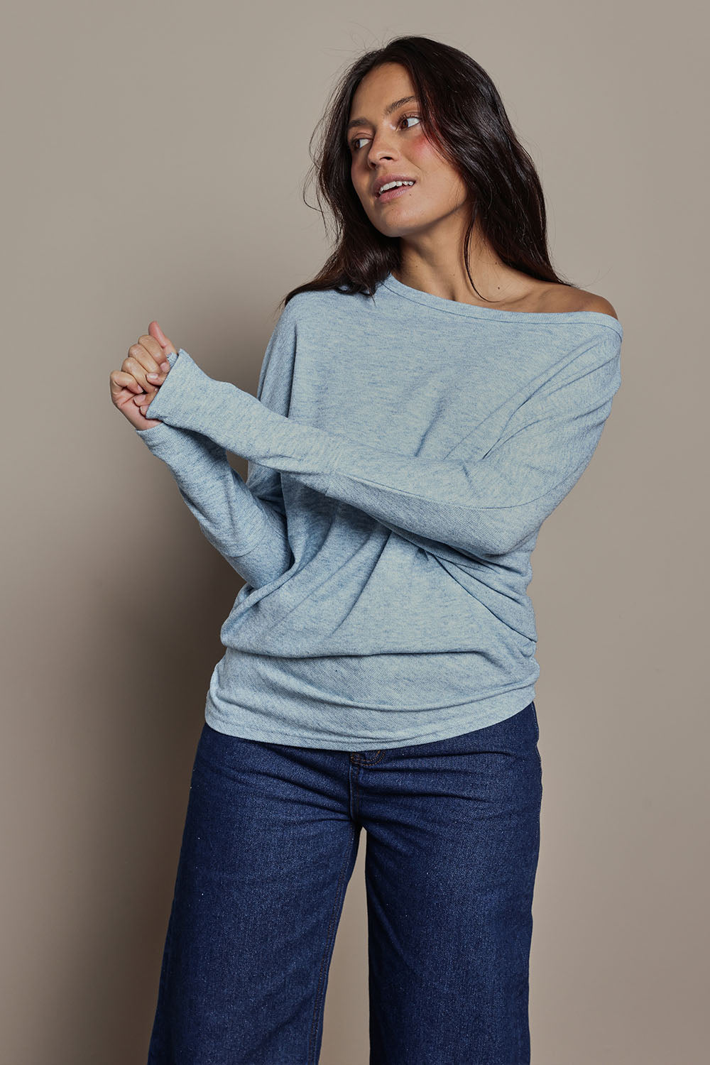 Model Tahnee wearing size 10 of the Snuggle Up Jumper in colour Skymarl (Blue), from the front, cropped image