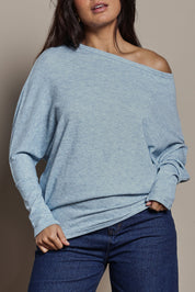 Model Tahnee wearing size 10 of the Snuggle Up Jumper in colour Skymarl (Blue), from the front, cropped image