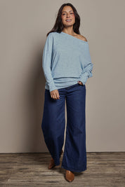 Model Tahnee wearing size 10 of the Snuggle Up Jumper in colour Skymarl (Blue), from the front, showing the whole outfit