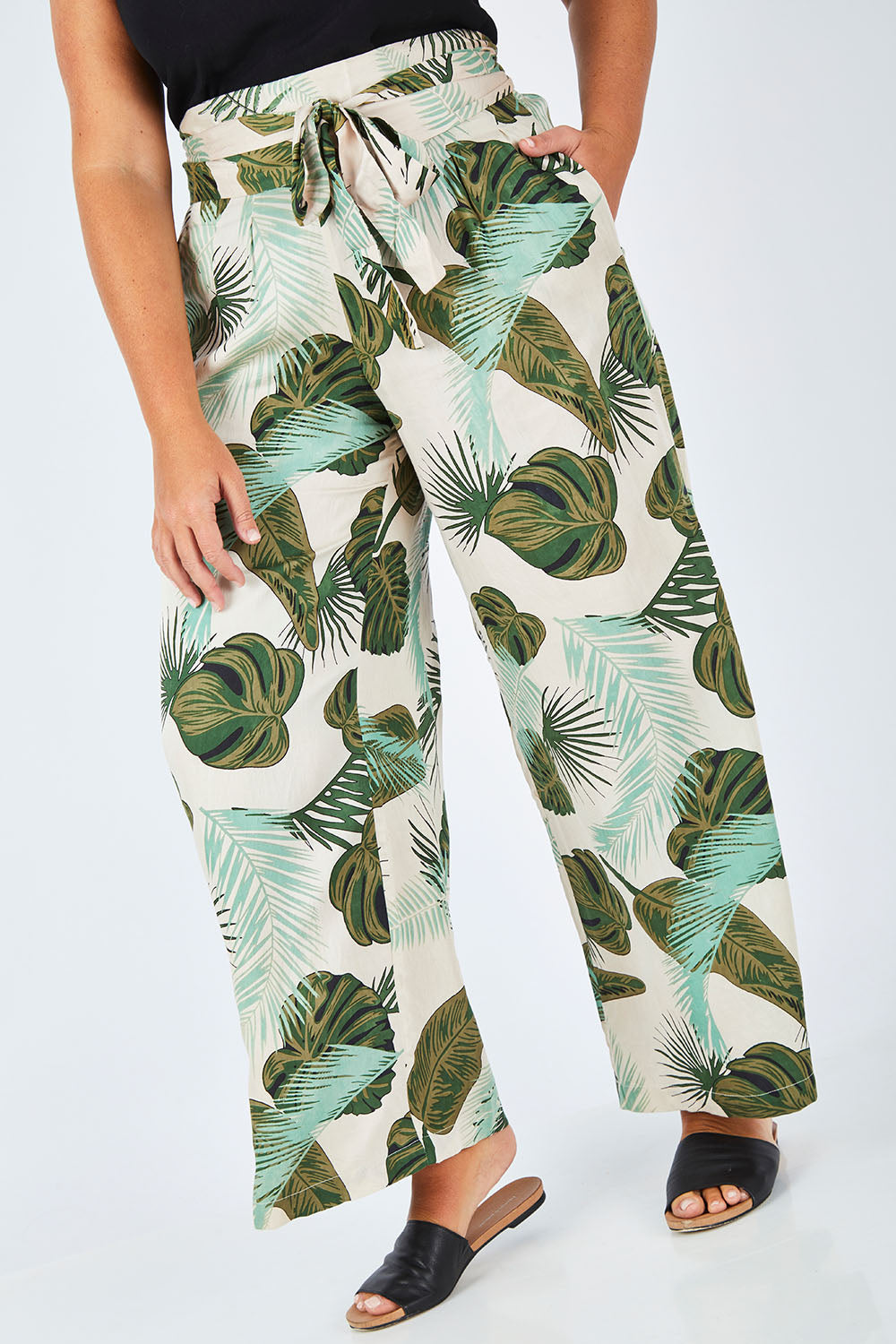 Model Fiona wearing size 16 of the To The Beat Of The Drum Pants in colour PinkFern (Pink), from the front, cropped image