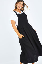 Model Palatina wearing size 14 of the Flow With Me Slouch Dress in colour Black (Black), from the front, cropped image