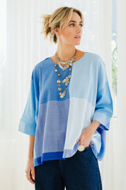 Model Tegan wearing size 10 of the Joy And Laughter Slouch Top in colour Blues (Blue), from the front, showing the whole outfit