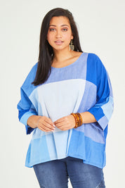 Model Terri-Leigh wearing size 14 of the Joy And Laughter Slouch Top in colour Blues (Blue), from the front, cropped image